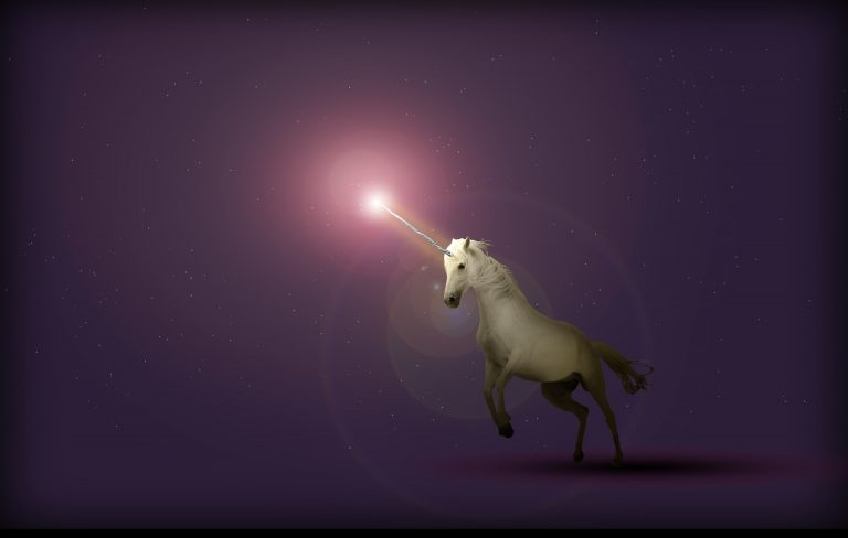 A unicorn with a glowing horn on a purple background