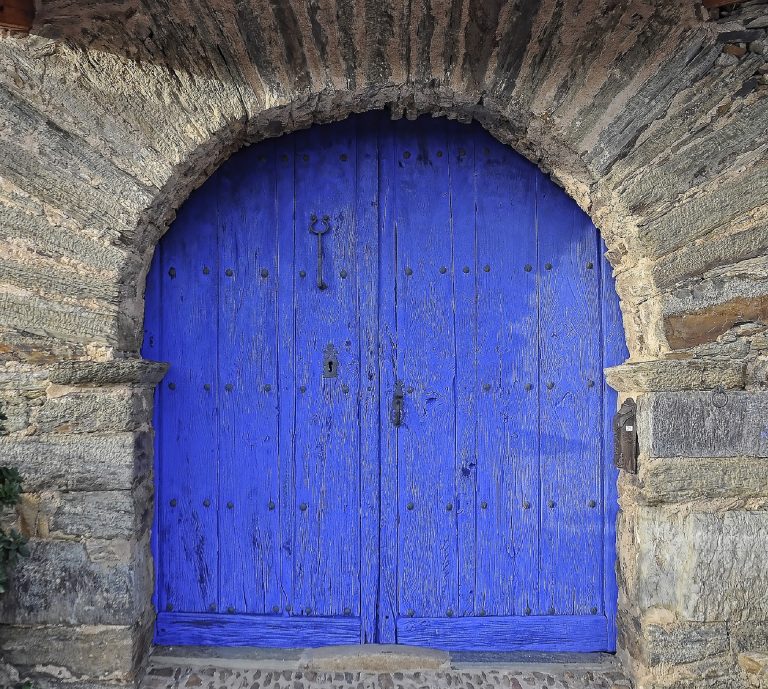 Blue double doors in an archway